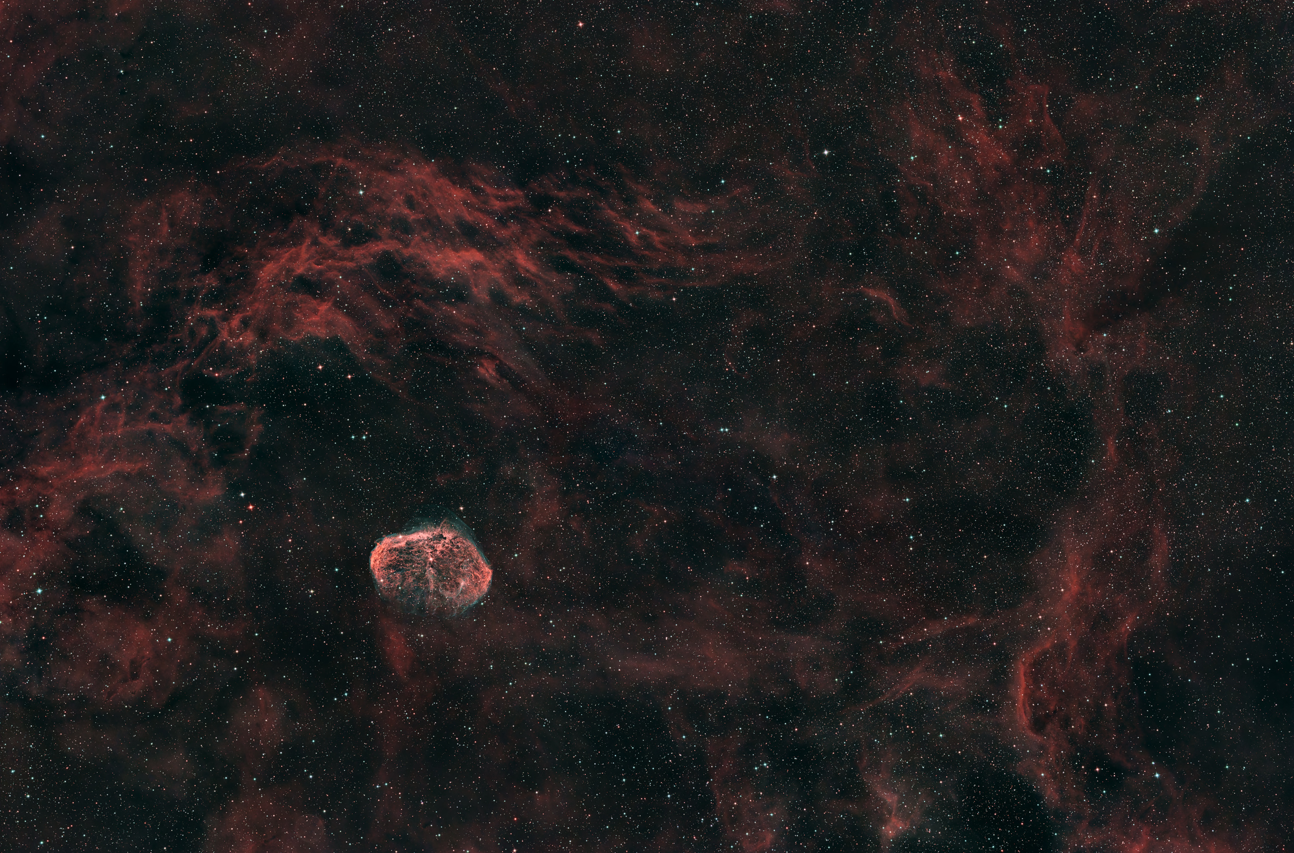 The Crescent Moon Nebula NGC 6888 is a peculiar emission nebula in the constellation Cygnus, excited to glow by the Wolf-Rayet star at the nebula's center.